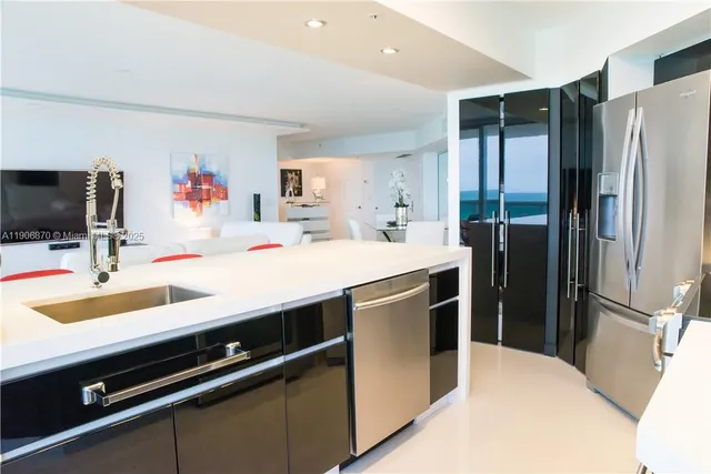 a kitchen with a sink appliances and cabinets