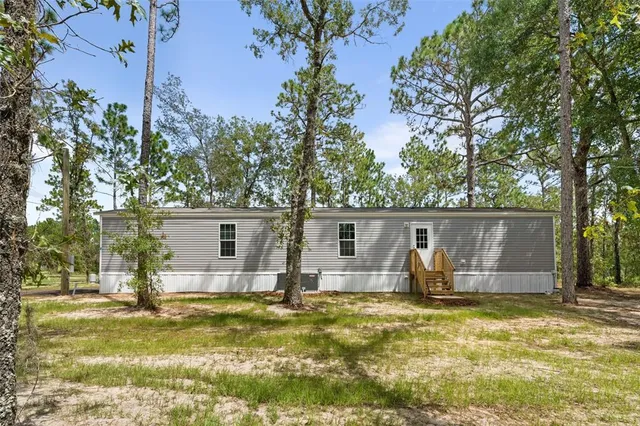 a backyard of house with yard and seating area