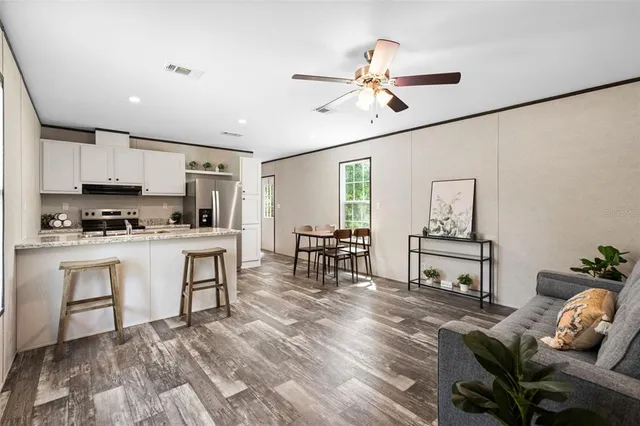 a kitchen with white cabinets and appliances