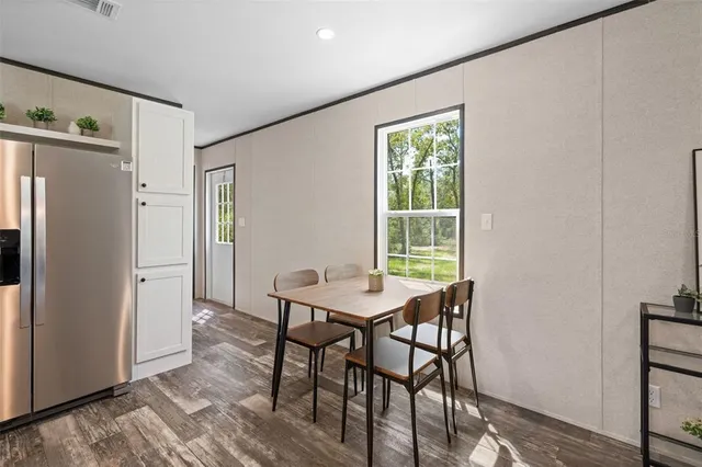 a view of a dining room with furniture window and wooden floor