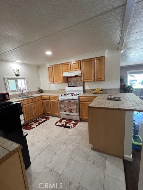 4901 Green River Road, Unit 104 Corona, CA 92878 - Photo 14 of 59 a kitchen with kitchen island granite countertop a stove top oven a sink dishwasher and cabinets with wooden floor