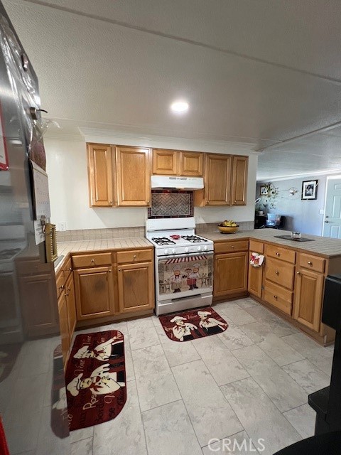 4901 Green River Road, Unit 104 Corona, CA 92878 - Photo 15 of 59 a kitchen with a cabinets and white appliances