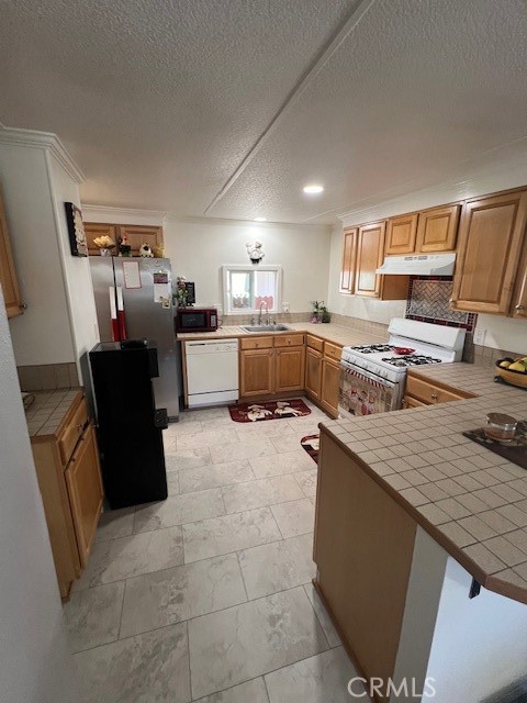 4901 Green River Road, Unit 104 Corona, CA 92878 - Photo 17 of 59 a kitchen with a sink stove and refrigerator