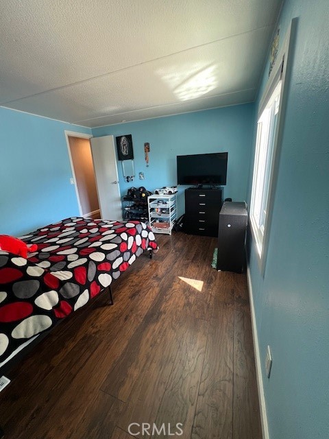 4901 Green River Road, Unit 104 Corona, CA 92878 - Photo 28 of 59 a bedroom with wooden floor and a fireplace