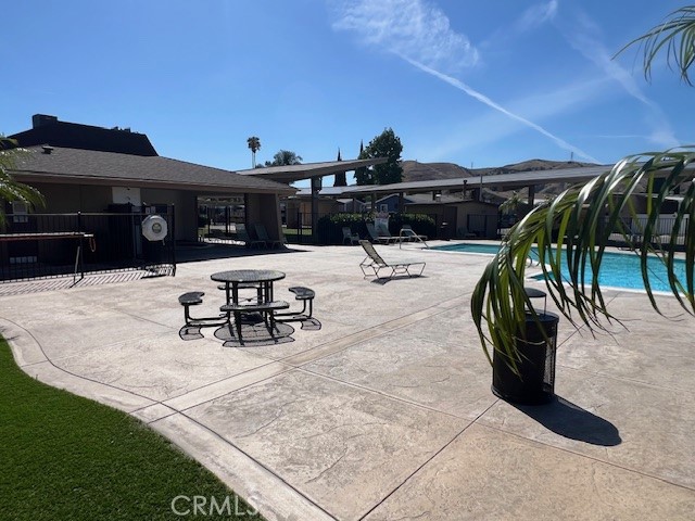 4901 Green River Road, Unit 104 Corona, CA 92878 - Photo 47 of 59 a view of a swimming pool with a patio