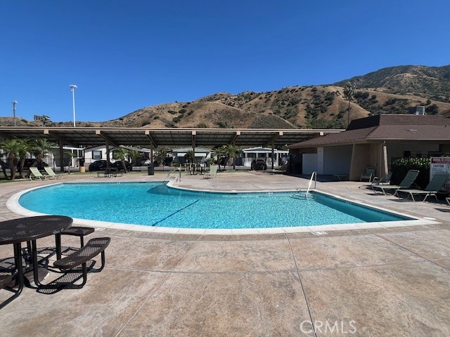 4901 Green River Road, Unit 104 Corona, CA 92878 - Photo 48 of 59 a view of a chairs and table on the terrace
