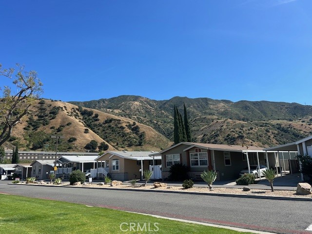 4901 Green River Road, Unit 104 Corona, CA 92878 - Photo 56 of 59 a front view of houses with yard and green space