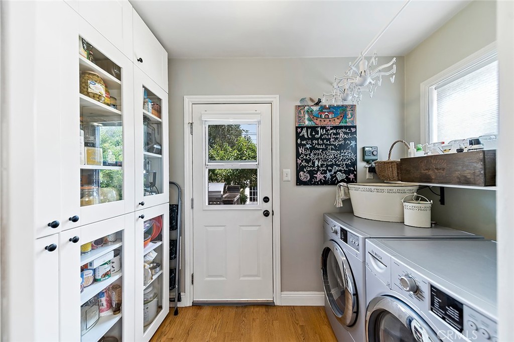 3432 Roxanne Avenue Long Beach, CA 90808 - Photo 11 of 41 a view of a kitchen with fridge and wooden floor