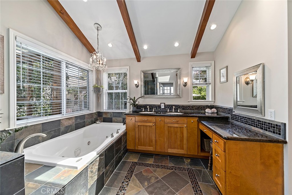 3432 Roxanne Avenue Long Beach, CA 90808 - Photo 22 of 41 a bathroom with a granite countertop tub sink and mirror