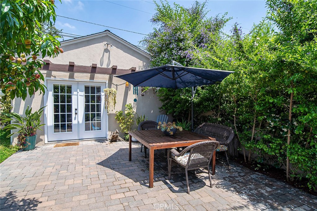 3432 Roxanne Avenue Long Beach, CA 90808 - Photo 27 of 41 a patio with a table and chairs under an umbrella