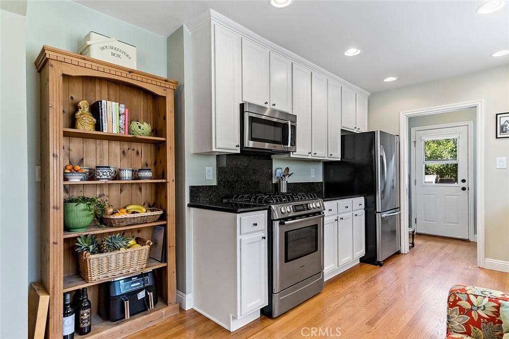3432 Roxanne Avenue Long Beach, CA 90808 - Photo 9 of 41 a kitchen with stainless steel appliances a stove a microwave and a refrigerator