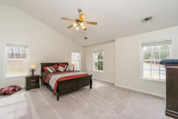 a spacious bedroom with a bed and window