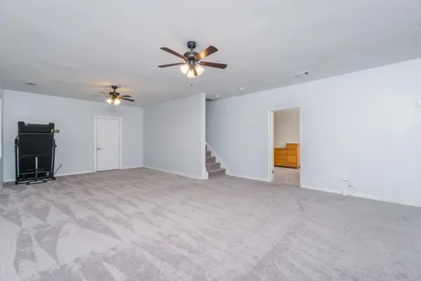 a view of empty room with a ceiling fan