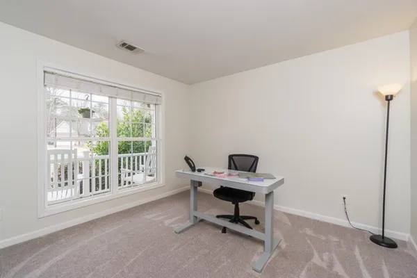 a work room with wooden floor and windows
