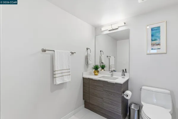 a bathroom with a sink vanity mirror and toilet