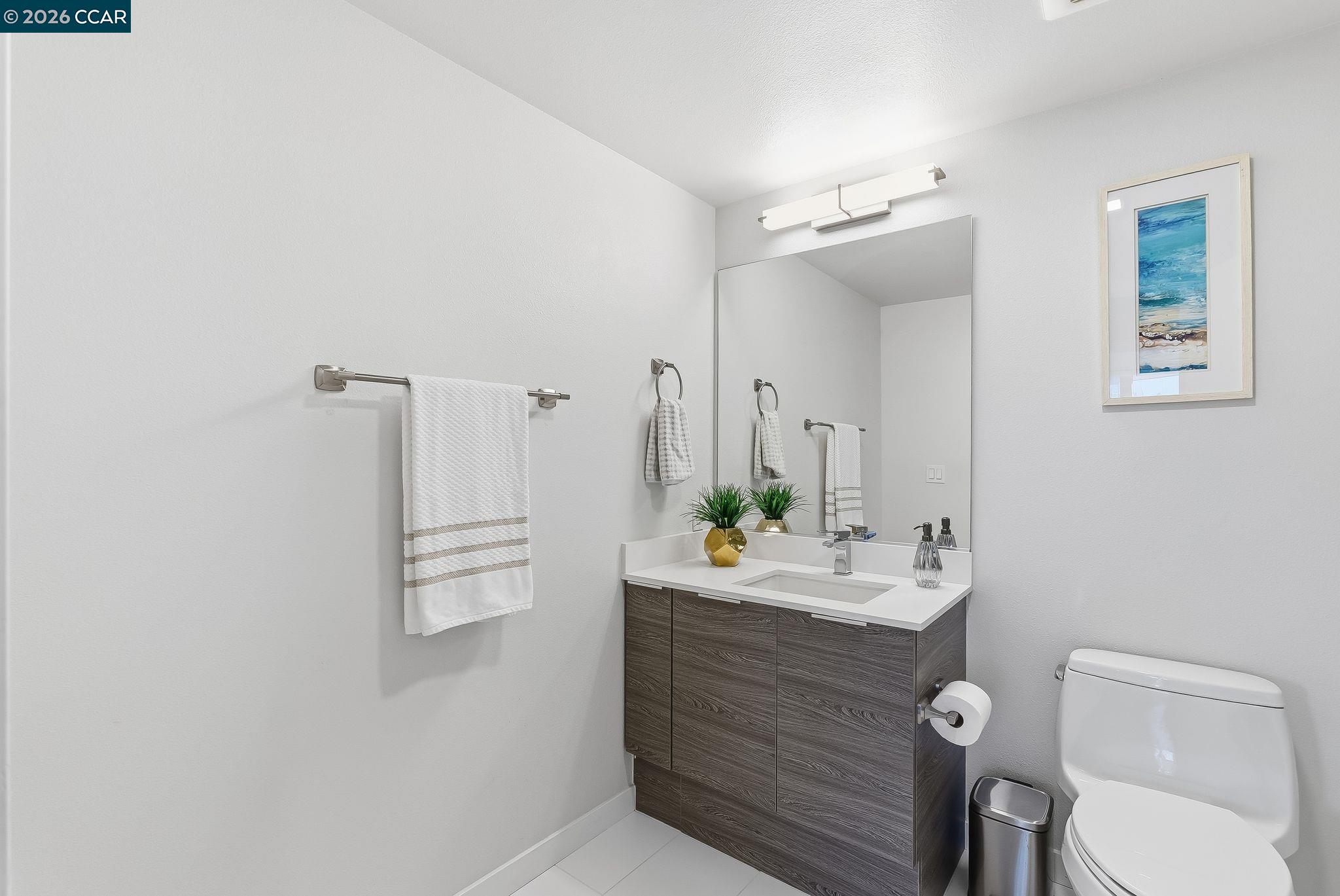 1605 Riviera Avenue, Unit 404 Walnut Creek, CA 94596 - Photo 13 of 45 a bathroom with a sink vanity mirror and toilet