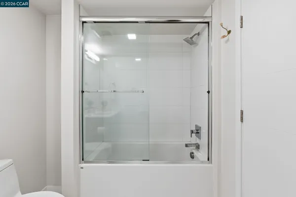 a bathroom with a glass shower door