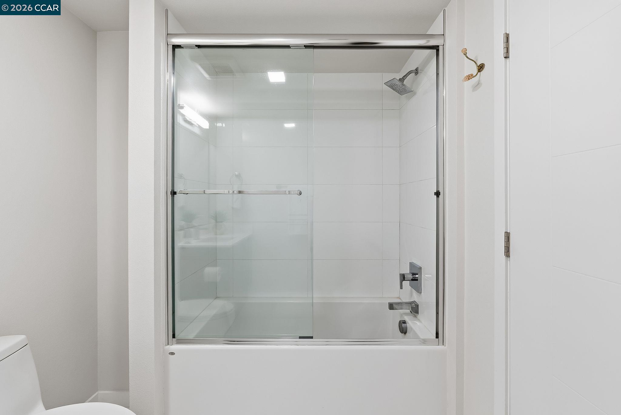 1605 Riviera Avenue, Unit 404 Walnut Creek, CA 94596 - Photo 14 of 45 a bathroom with a glass shower door