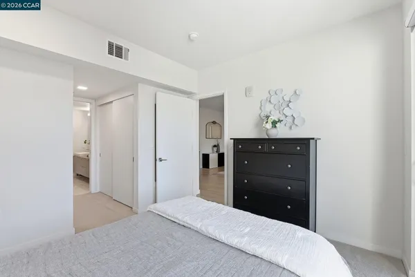 a bedroom with a bed and a dresser