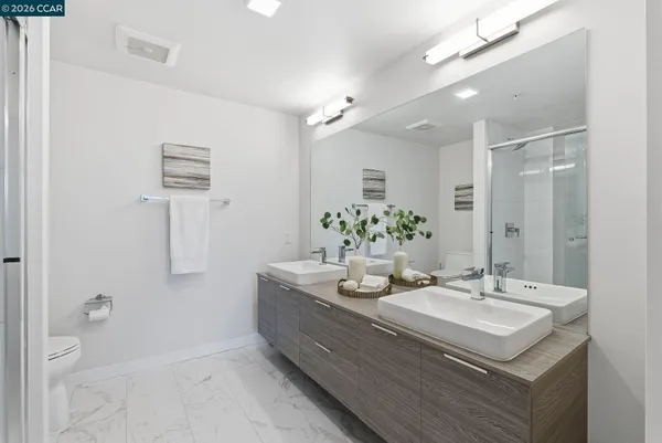 a bathroom with a sink vanity granite and a mirror