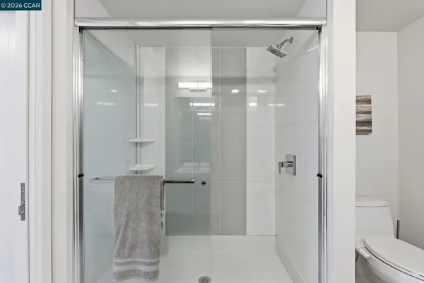 a bathroom with a glass shower door