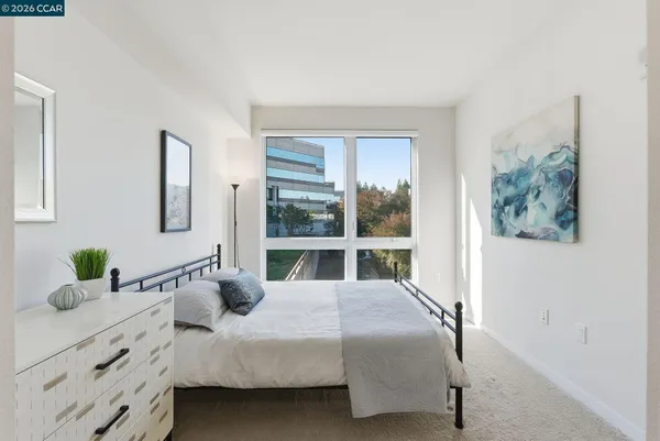 a bedroom with a large bed and a large window