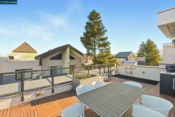 a balcony with wooden floor and outdoor seating