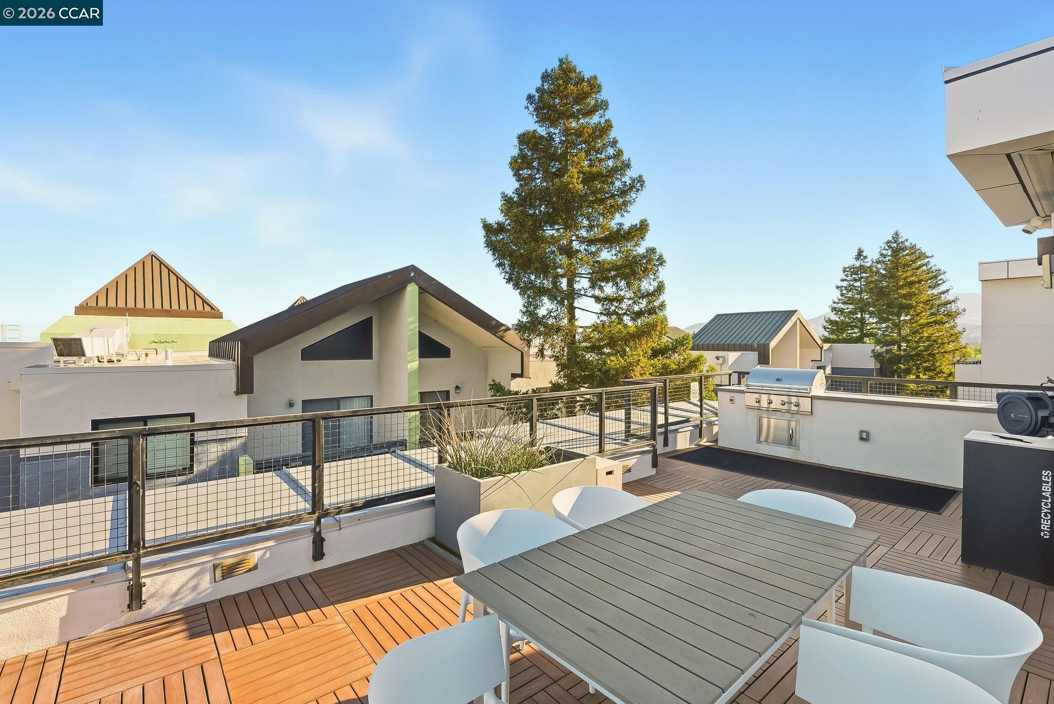 1605 Riviera Avenue, Unit 404 Walnut Creek, CA 94596 - Photo 25 of 45 a balcony with wooden floor and outdoor seating