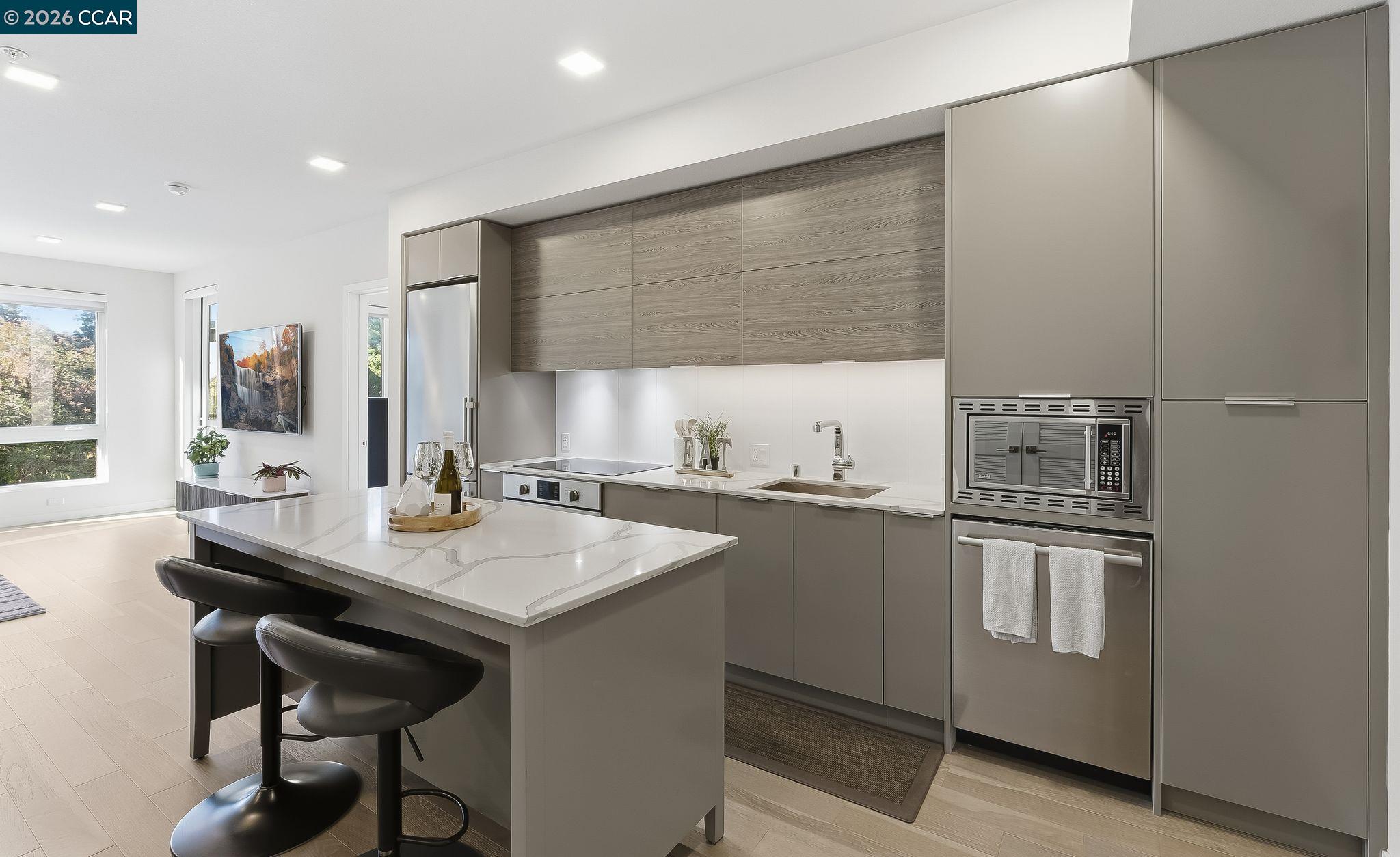 1605 Riviera Avenue, Unit 404 Walnut Creek, CA 94596 - Photo 6 of 45 a kitchen with stainless steel appliances granite countertop a sink and cabinets