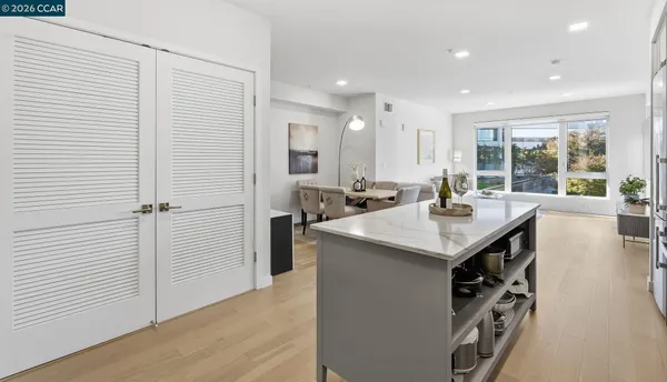 a kitchen with counter top space and windows