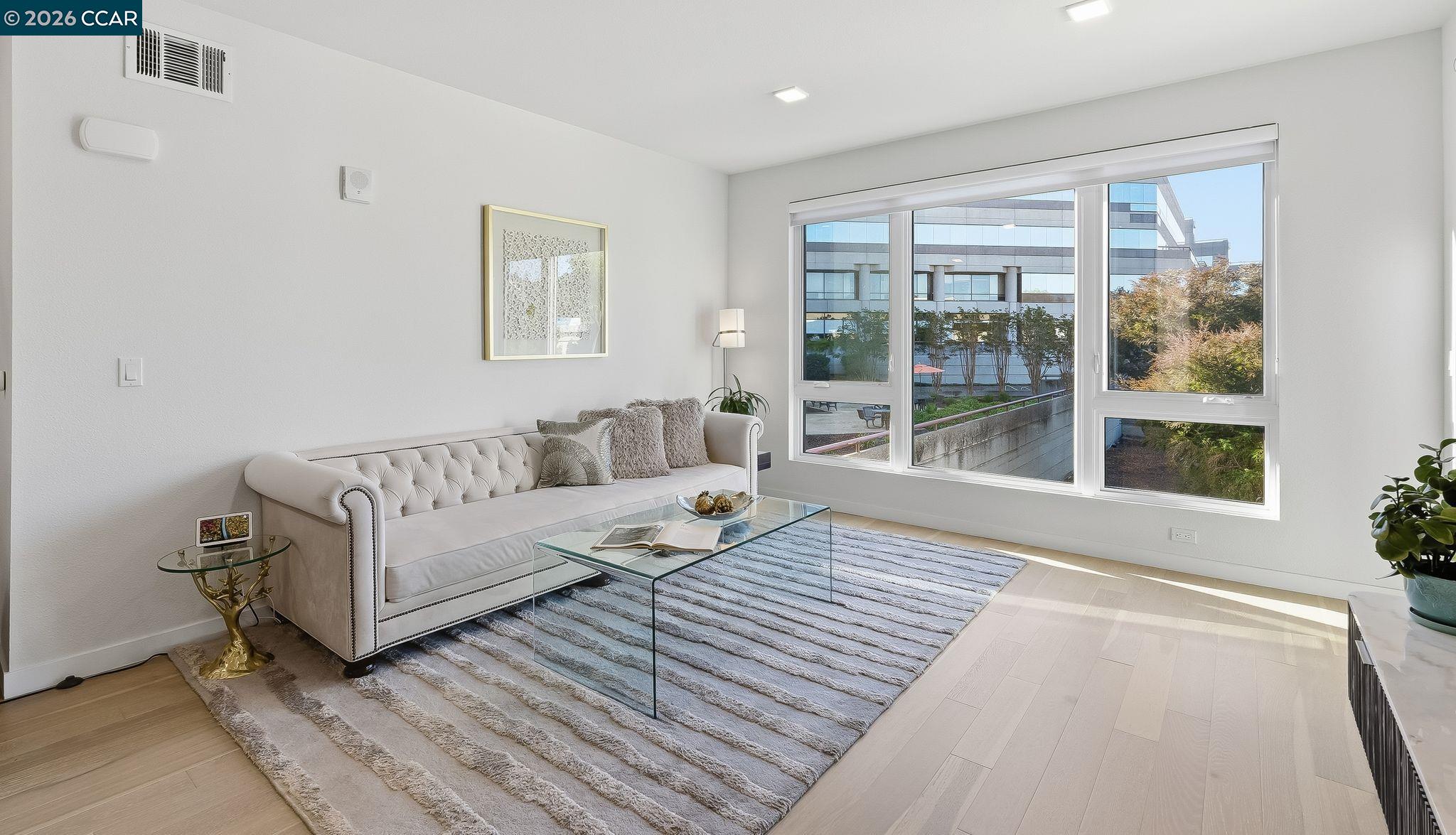 1605 Riviera Avenue, Unit 404 Walnut Creek, CA 94596 - Photo 10 of 45 a living room with furniture and a large window