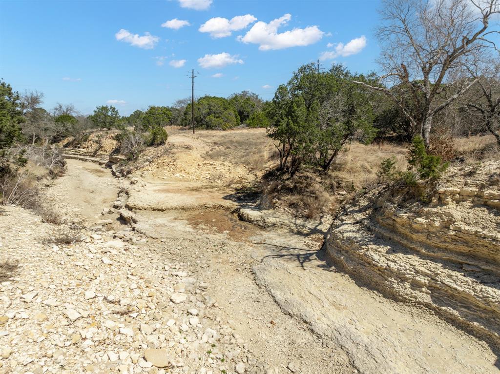 Lot 16-ph Private Road Evant, TX 76525 - Photo 5 of 23 a view of a dry yard covered with snow in the background