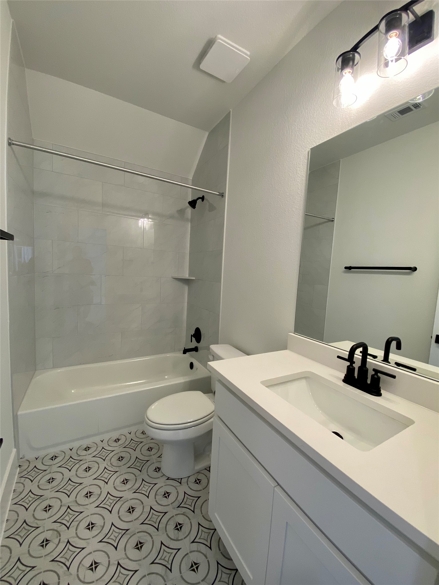 17341 Graces Path Pflugerville, TX 78660 - Photo 2 of 13 a bathroom with a sink a toilet a mirror and bathtub