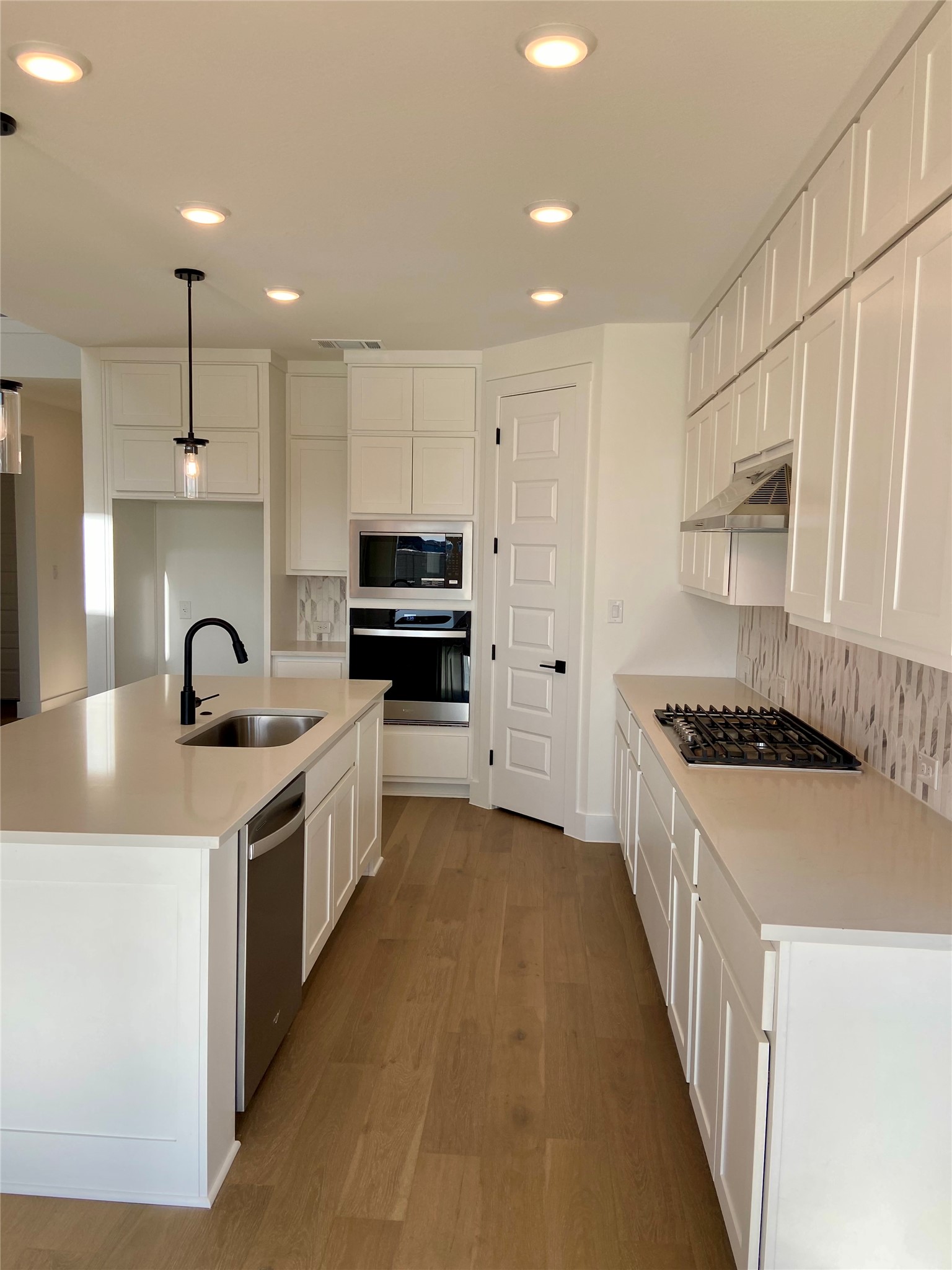 17341 Graces Path Pflugerville, TX 78660 - Photo 5 of 13 a kitchen with stainless steel appliances granite countertop a sink stove and refrigerator