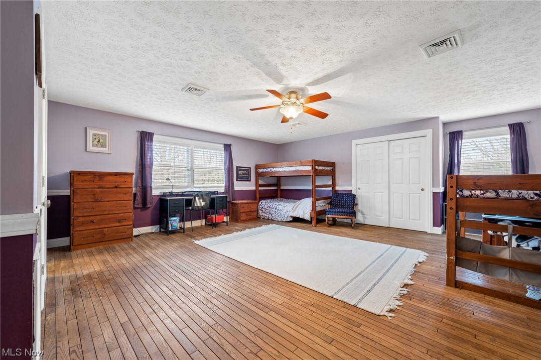 2425 McMackin Road Madison, OH 44057 - Photo 27 of 46 Home office with dark wood-type flooring, ceiling fan, and a textured ceiling