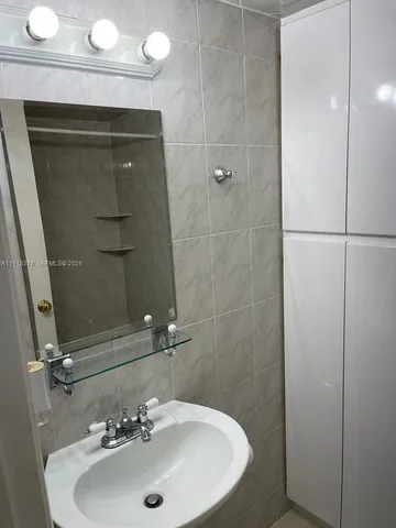 a bathroom with a sink and mirror