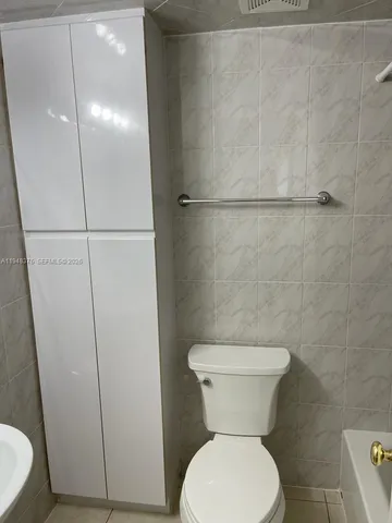 a bathroom with a toilet and a sink