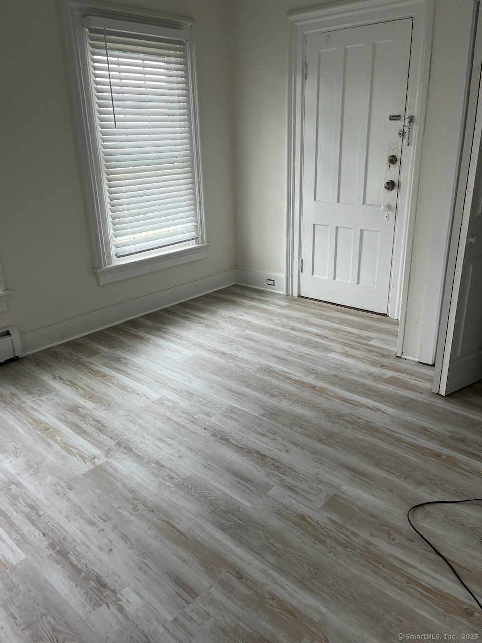 568 Danbury Road New Milford, CT 06776 - Photo 1 of 6 an empty room with wooden floor and windows