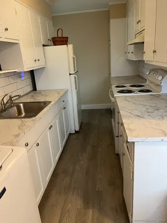 a kitchen with a sink a stove and refrigerator