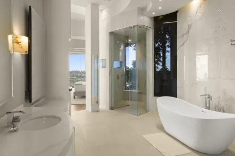 a spacious bathroom with a bathtub and sink