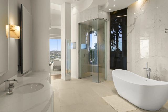 a spacious bathroom with a bathtub and sink