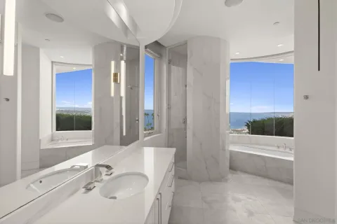 a bedroom with a bed and a view of living room