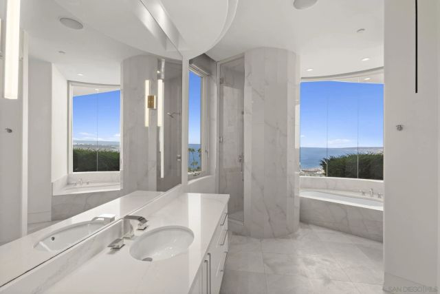 a bedroom with a bed and a view of living room