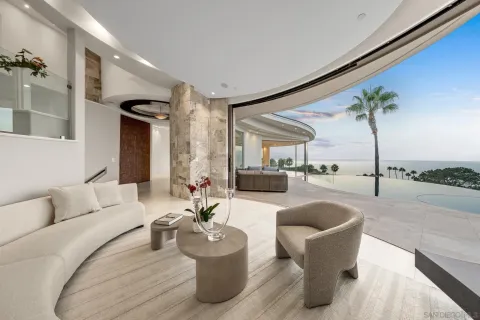 a living room with furniture and a floor to ceiling window