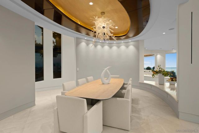 a dining room with furniture and a chandelier