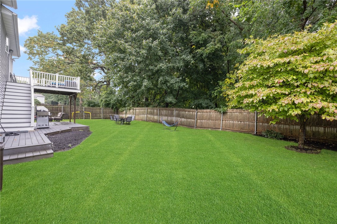 13 Lawrence Road North Providence, RI 02911 - Photo 26 of 31 The property is fully fenced for safety and convenience. Large trees provide additional privacy but are at a safe distance from the house.