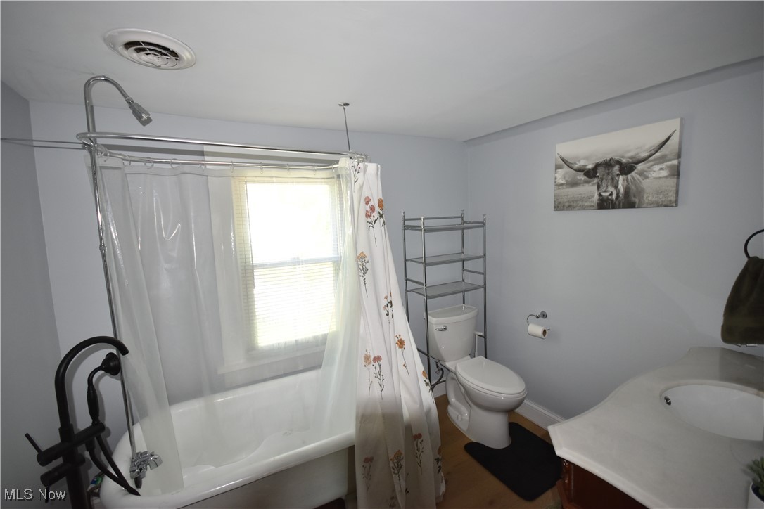 808 West Riddle Avenue Ravenna, OH 44266 - Photo 14 of 28 Full bathroom featuring shower / tub combo, vanity, wood-type flooring, and toilet