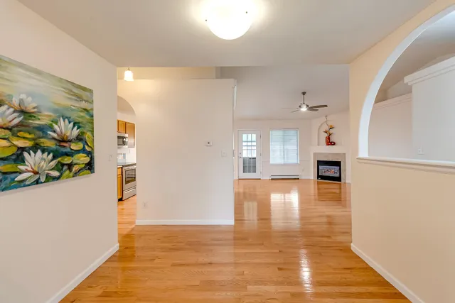a view of empty room with wooden floor