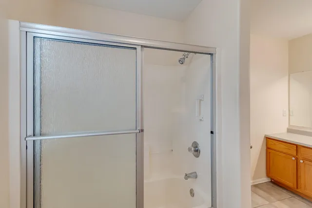 a bathroom with a glass shower door