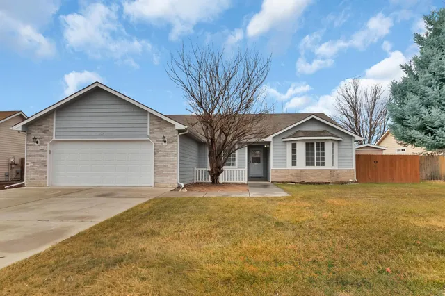 a front view of house with yard outdoor seating and barbeque oven